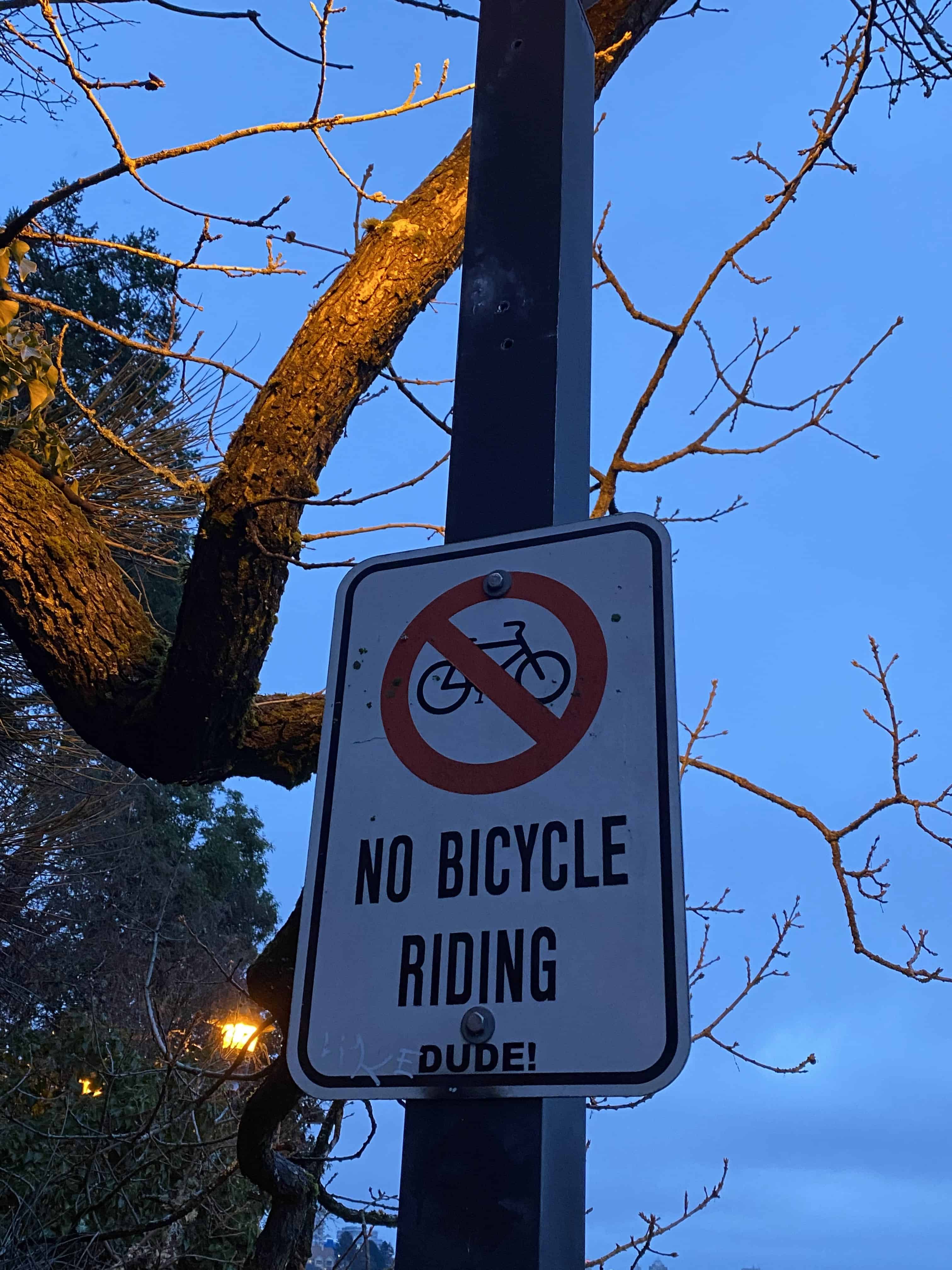 No Bicycle Riding Sign posted at WestSong Walkway entrance. Pedestrian access only makes this one of the best walking trails in Victoria BC