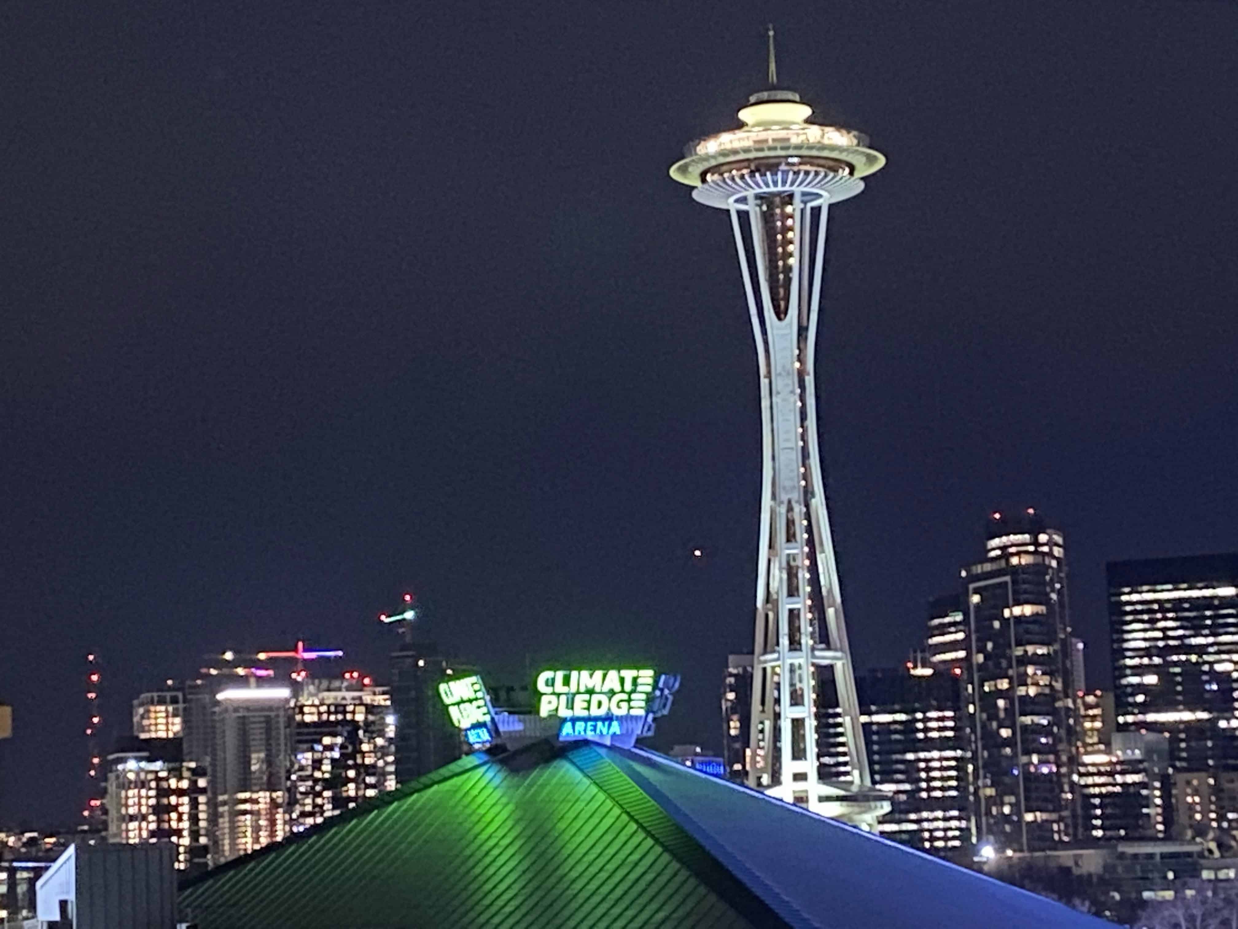 Seattle Space Needle looking over Climate Pledge Arena
