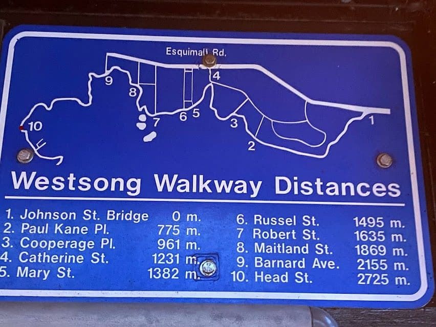 This is the blue sign on Westsong Walkway on the WestBay (Esquimalt) side entrance off Head Street showing distances to walk to Victoria (Johnson Street Bridge)