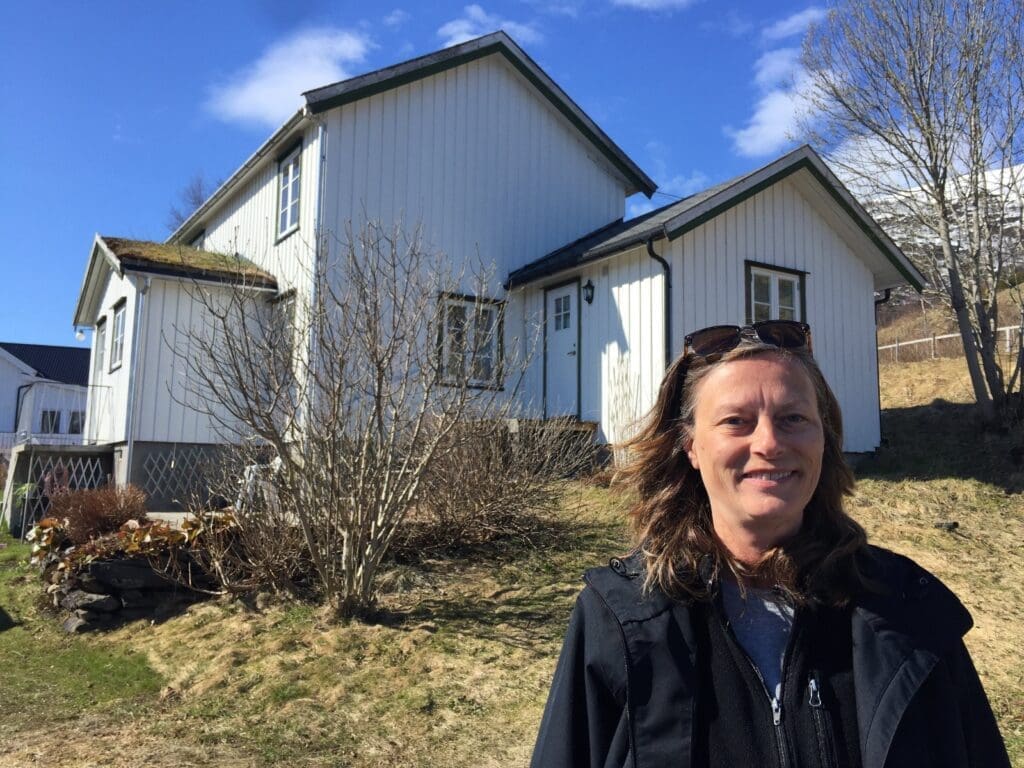 Gail standing in front of the house my grandmother Julia Rasmussen lived as a child.  Ancestry Trip to &Oslash;rnes Norway