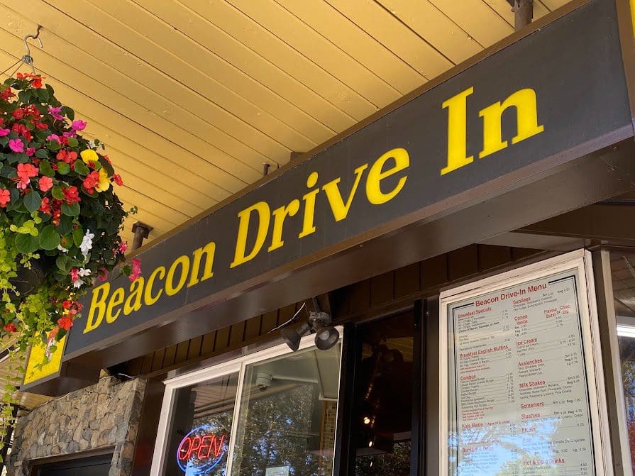 Beacon Drive In (restaurant) sign with menu outside.