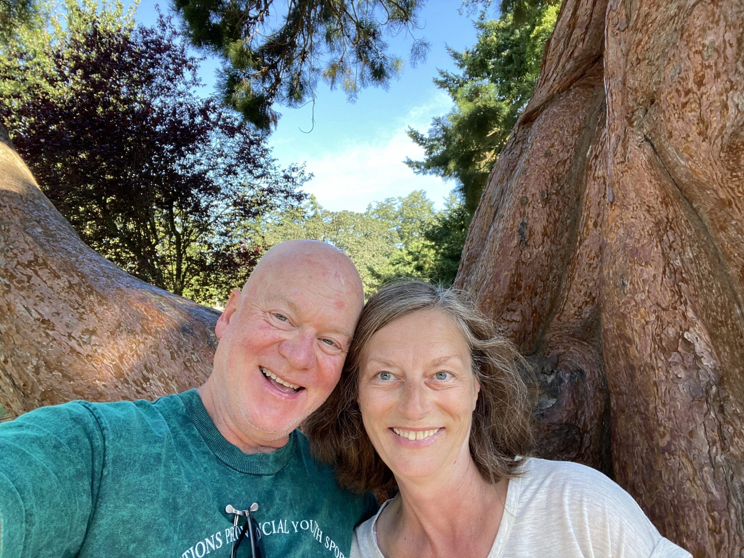 Gail and Paul posing with the Sequoia Tree located in Beacon Hill Park Victoria BC