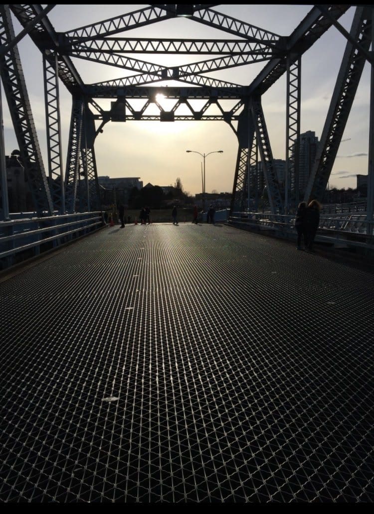 People walking on the old Johnson Street Bridge, the day it became no longer in service - this is the Blue Bridge sunset picture.