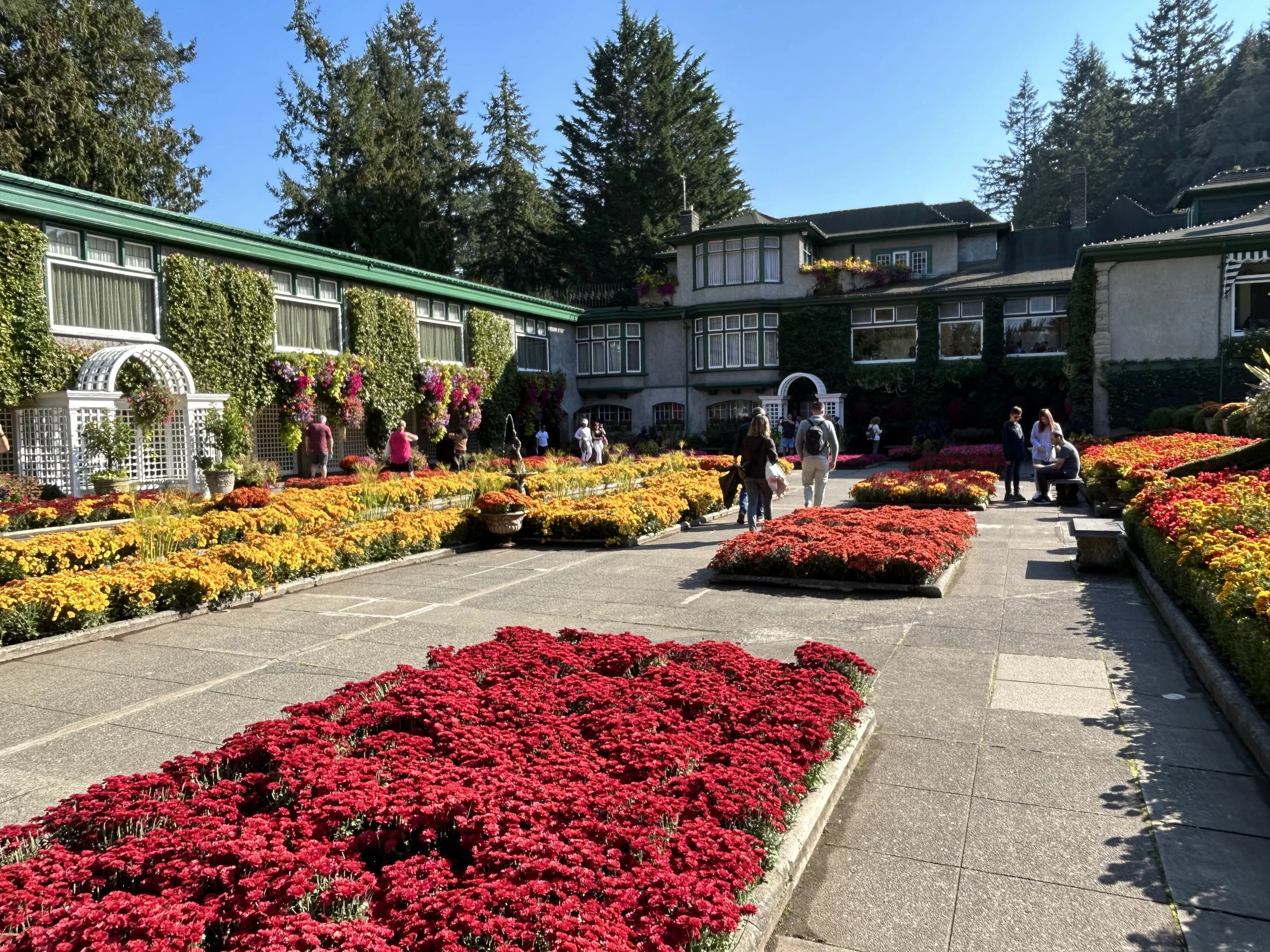 Butchart Gardens is in Brentwood Bay- Victoria, BC and nearby, and this picture was taken in the fall/autumn, with blossoms still plentiful in the gardens.