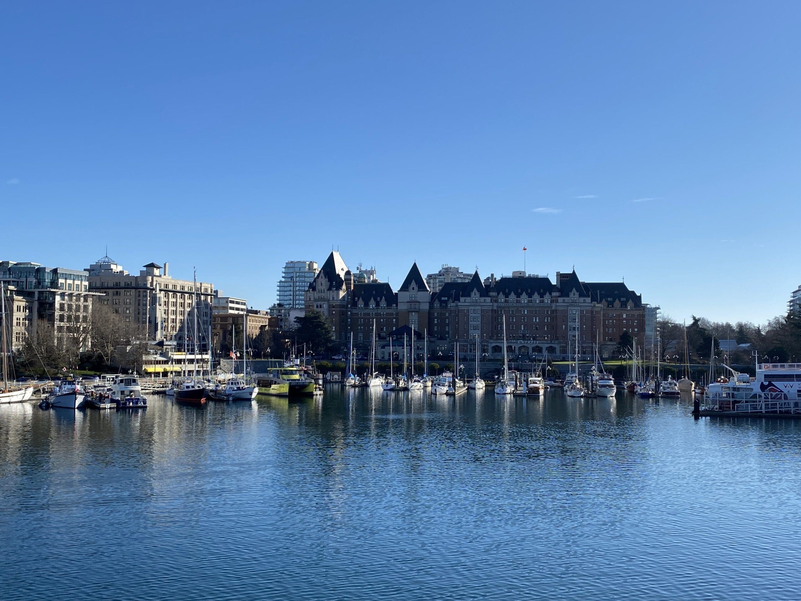 The beautiful Victoria BC Harbour with the Empress Hotel in front. Another place where a top bucket list activity, high tea or afternoon tea at the Empress can be found.