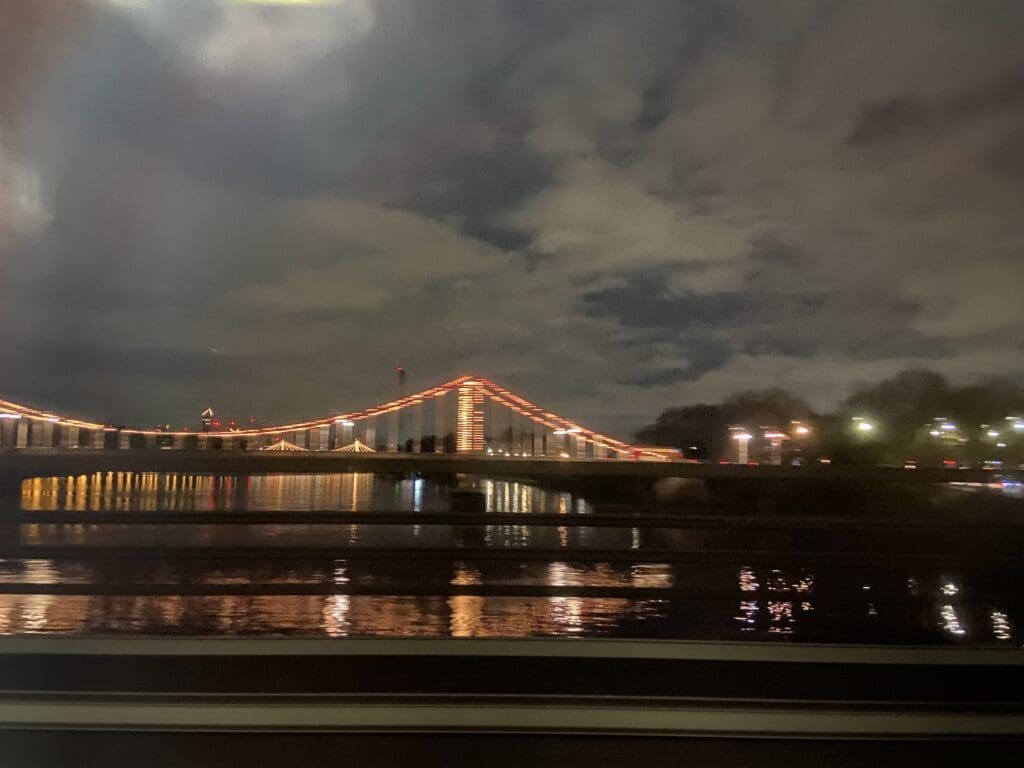 The Chelsea Bridge illuminated. View and picture taken from the train on Grosvenor Bridge.