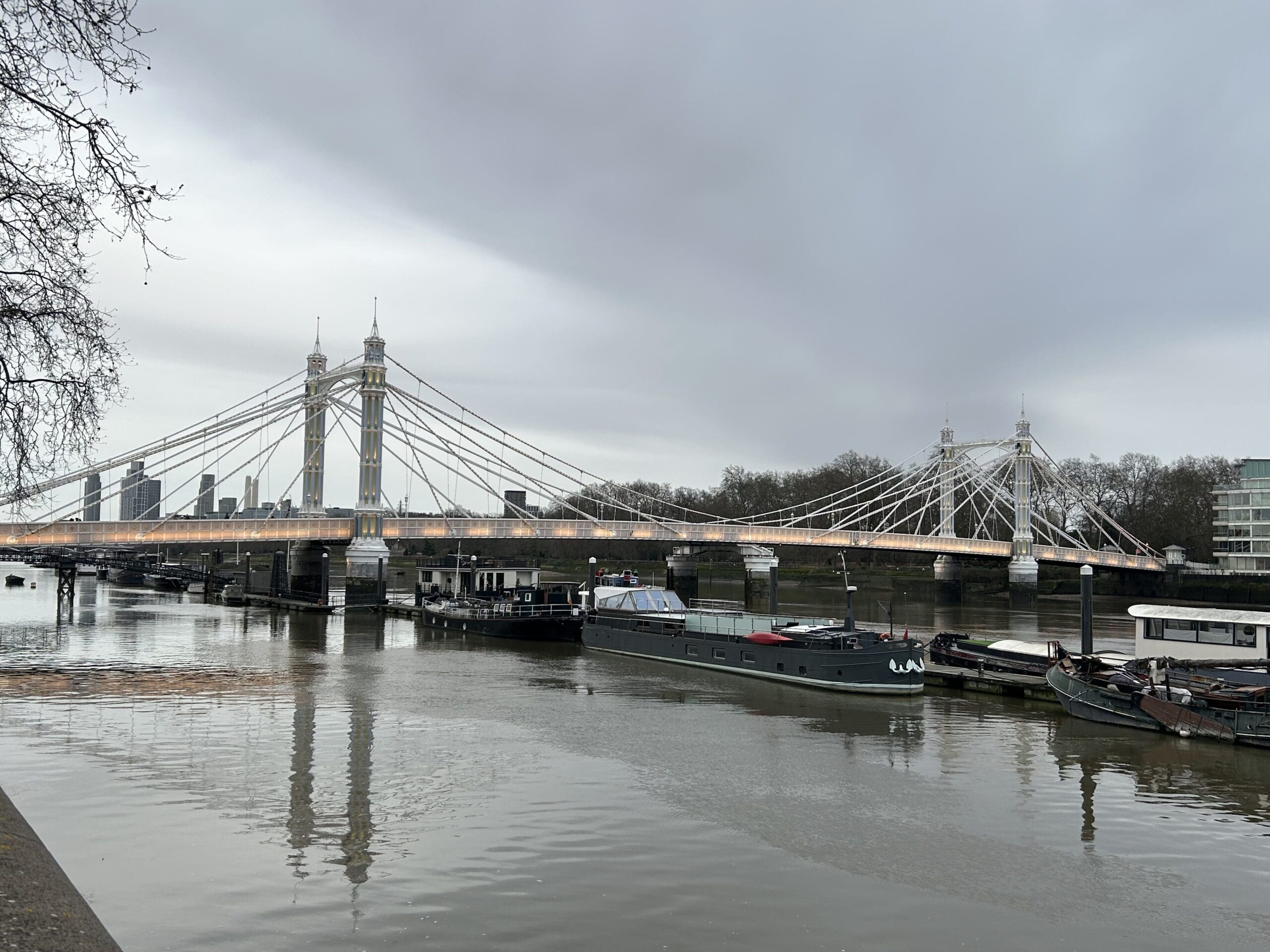 Albert Bridge in London wih the glimmer of he lights just barely showing at dusk.